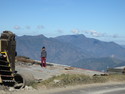 Boy standing on edge of mountain