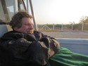 Brad in the back of a truck hitchhiking to mandalay