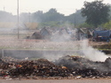 Burning garbage in front of shanty town
