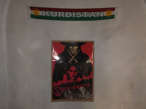 Kurdistan banner, V for Vendetta poster hanging in hosts house in Mardin