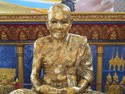 This is a statue made from coating a real human monk in gold after he died. His picture is shown just below the statue.