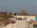People and kites on the roofs of ahmedabads old city