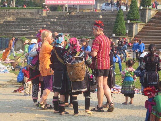 Hmong villagers pushing their wares on some Russians