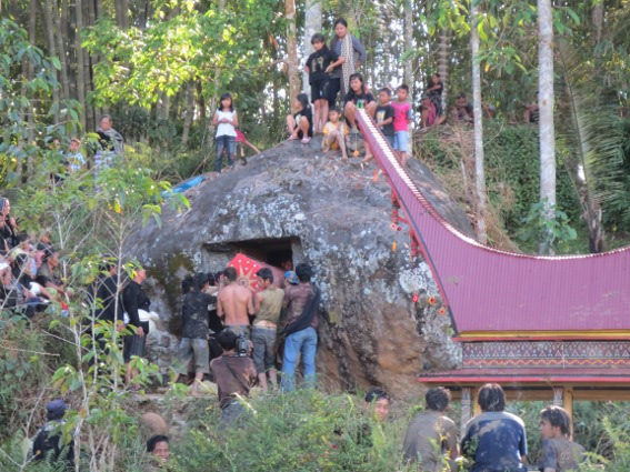 Lempo villages loading a coffin into a rock cave in the mountains of Tana Toraja