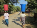 Women with large pails on their heads